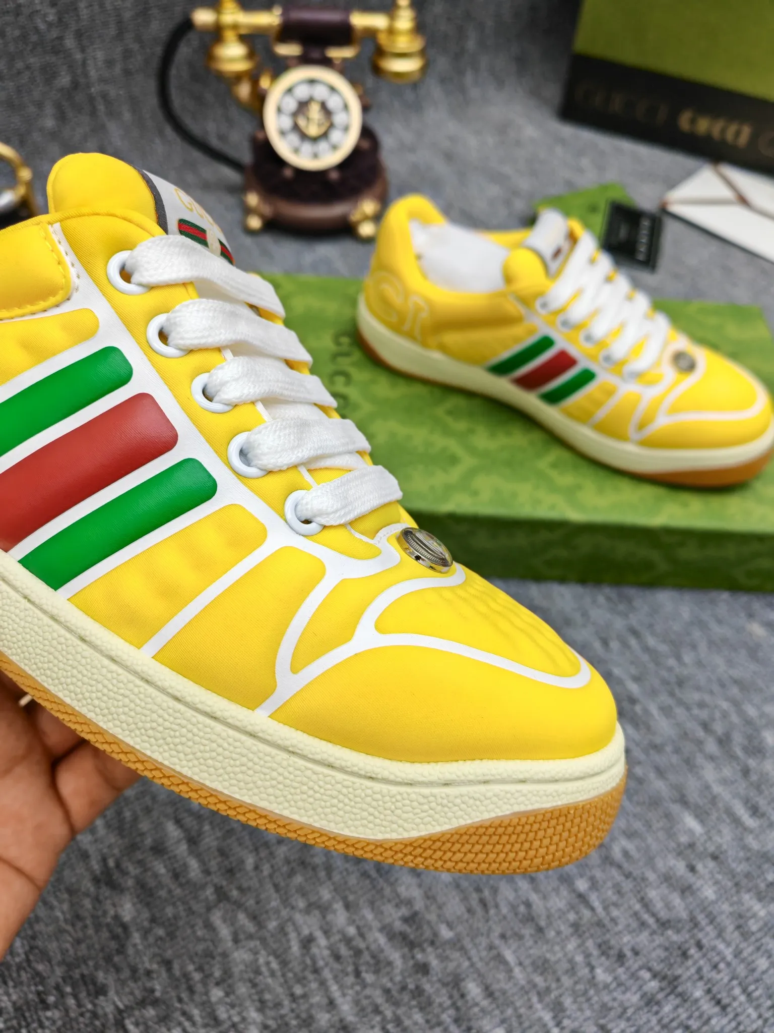 Factory price 600💰Screener series embellished web sneakers. This item is from the Gucci Lido series. Its design is inspired by the summer style and beach clubs of the Italian coast. The Screener series of sneakers draws inspiration from classic sneakers from the 1970s and takes its name from a special defensive move in sports. This shoe from the 2024 Pre-Fall collection is crafted from yellow rubber, a technical and malleable opaque material, with striped webbing on the sides and an embossed Gucci printed logo on the heel. Yellow rubber, opaque and technological in appearance. Red and green webbing decorated with metal Double G oval enamel details. Gucci printed embossed logo. Women 35-40, men 38-45, (men 38 and 45 need to be customized)